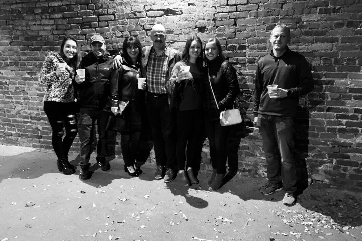 group of people in front of brick wall