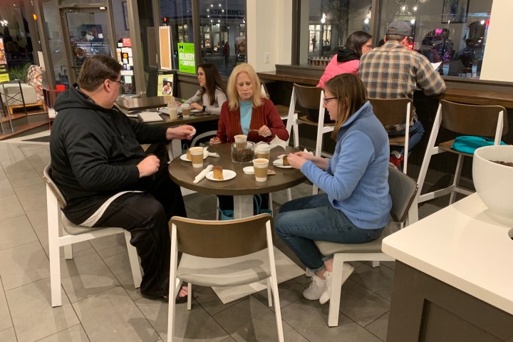 a group of people sitting at a table in a restaurant