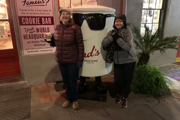 a man and a woman standing in front of a building