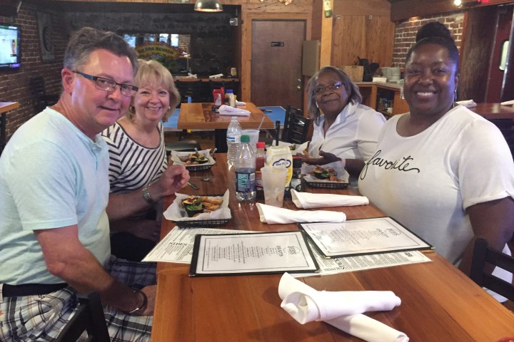 a group of people sitting at a table in a restaurant