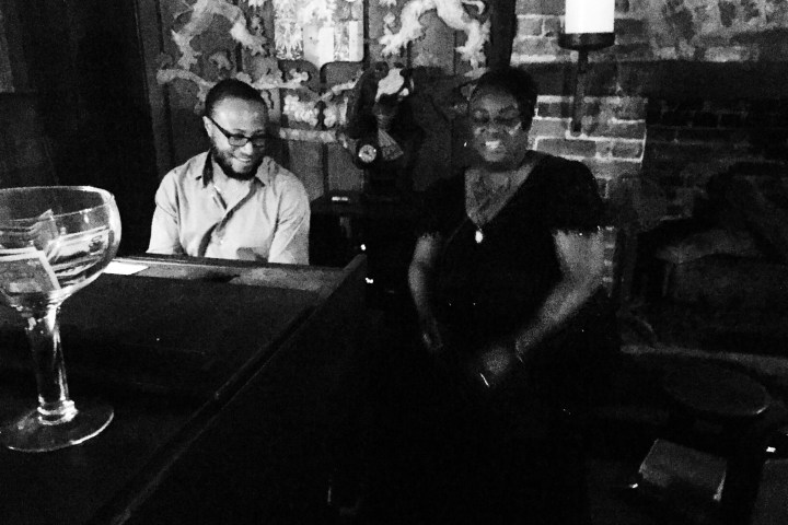 a person sitting at a table with wine glasses