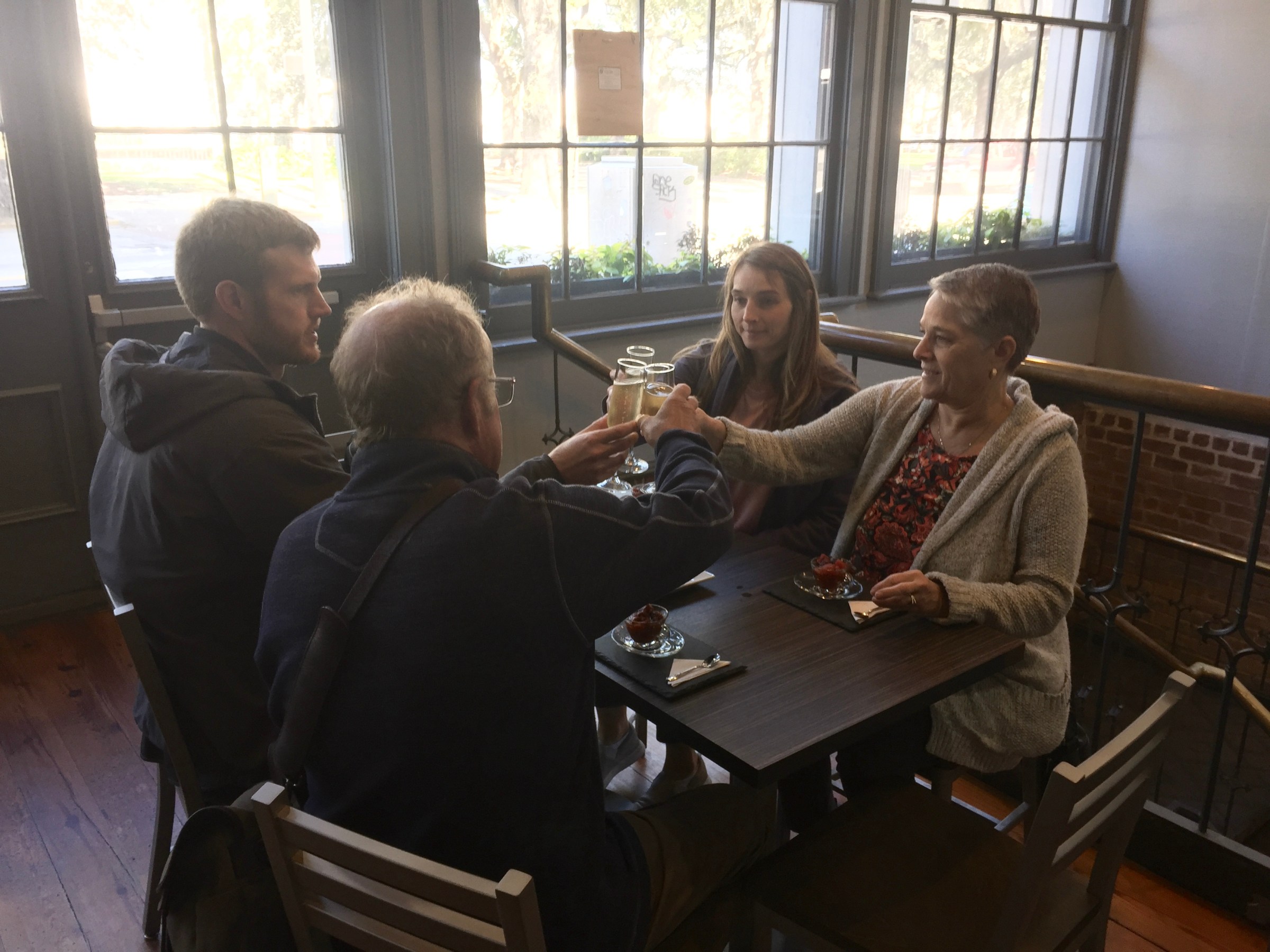 a group of people sitting at a table with a laptop