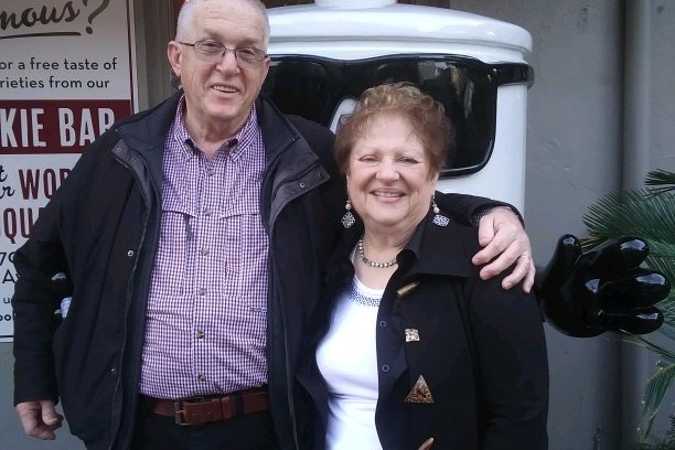 a man and a woman standing in front of a building