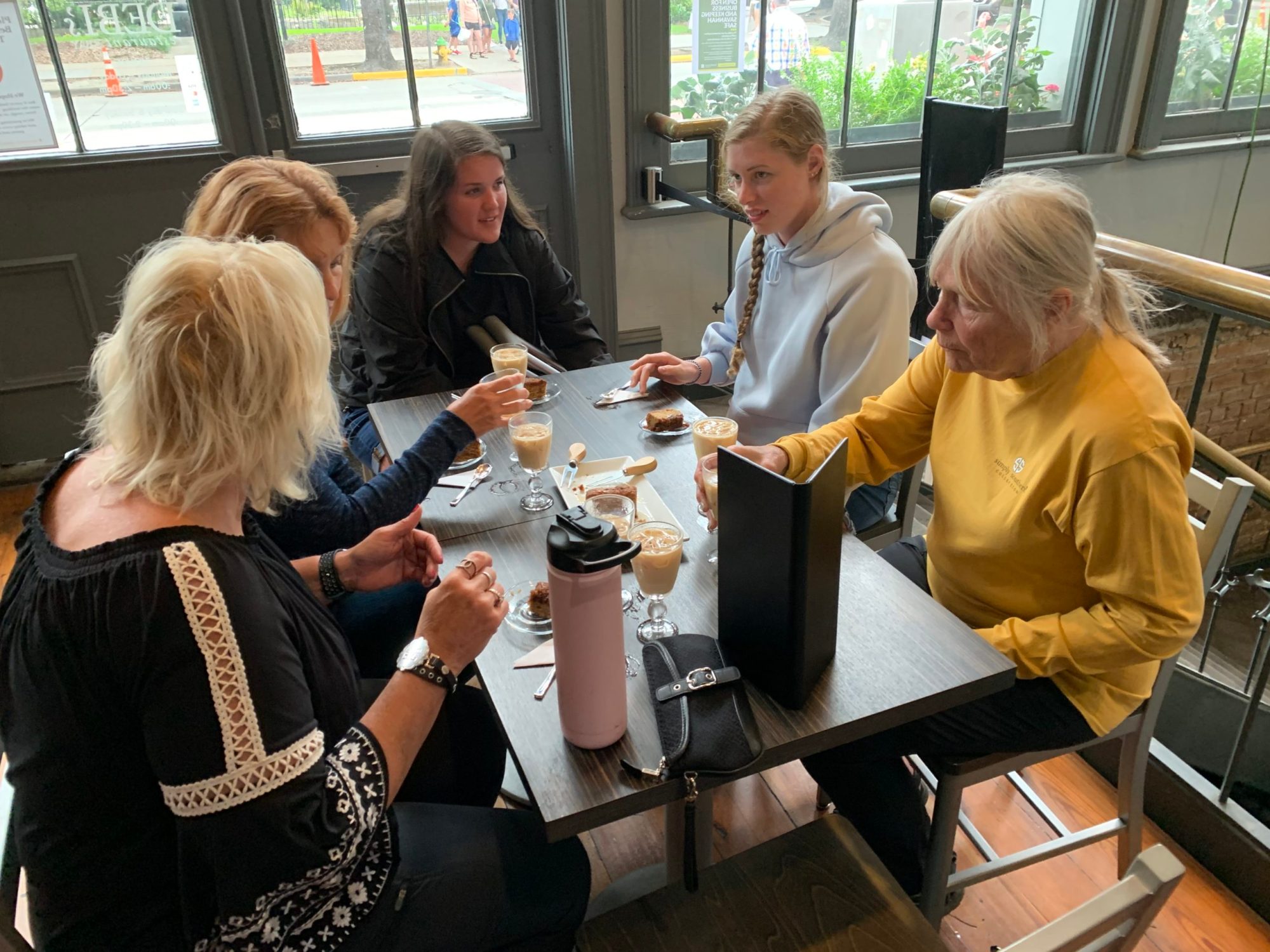 a group of people standing around a table