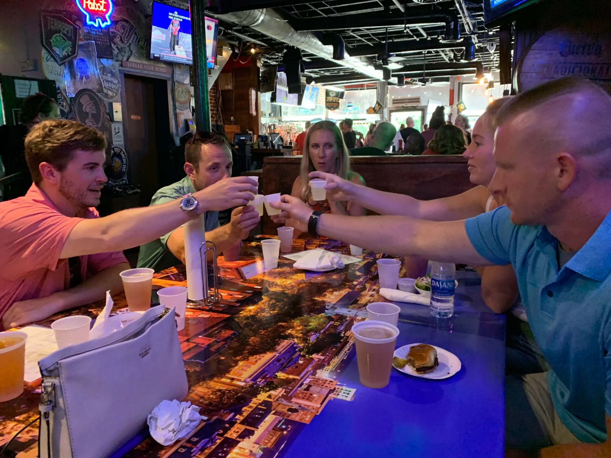 a group of people sitting at a table eating food